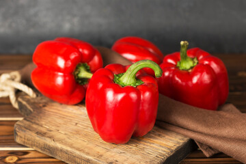 red  fresh ripe peppers on a wooden board