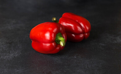 red fresh ripe paprika on wooden board