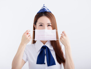 Young woman air hostess in  uniform with white mask