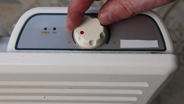 Setting convector heater thermostat by turning dial to off position.