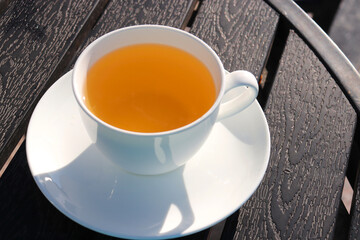 A Cup of green tea on black wooden background. Cleansing or detox tea is a good option for weight loss. Antioxidant properties. Copy space