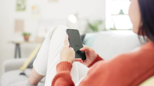 Hands, phone screen and online shopping for woman on living room sofa with typing, scroll and choice. Smartphone, ecommerce website and girl on lounge couch for digital store, checkout and product