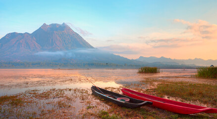 Fishing village on the coast of the Lake Batur on the background Volcanic Batur Mountain - Bali,...