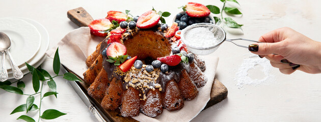 Pound Cake cake with strawberry, close-up on the table. Horizontal view from above..Pound Cake cake with mint and strawberry close-up on the table. Horizontal view from above.