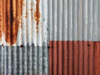 Closeup old and rusty corrugated zinc sheet wall, grunge background metal texture