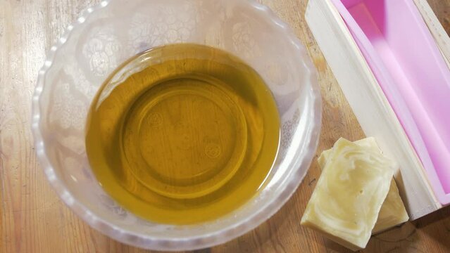 Melted oils for making cold-process soap laid out on table
