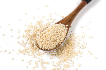 white sesame seeds in wooden spoon isolated on white background.