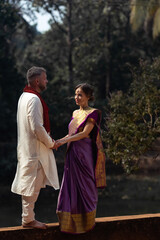 Wedding of a couple from Europe in India. A light skinned man in a traditional Indian men. white skin. Bride in beautiful sari with mehendi. Caucasian marriage. International couple.Lovely couple fit 