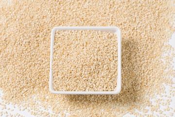 white sesame seeds in plate background.