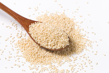 white sesame seeds in wooden spoon isolated on white background.