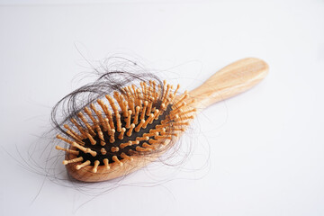 Hair loss fall with comb brush isolated on white background.