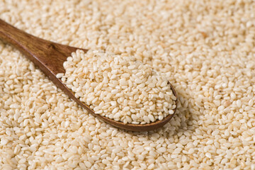white sesame seeds in spoon texture background.