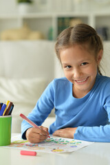 Cute little preschooler child drawing at home