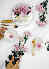 Selective focus of Decorated by flowers white naked cake, rustic style for weddings, birthdays and events. On brown background. Selective focus. In kitchen. Food Stilllife 
