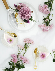 Selective focus of Decorated by flowers white naked cake, rustic style for weddings, birthdays and events. On brown background. Selective focus. In kitchen. Food Stilllife 