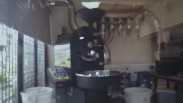 Blurred of coffee beans in roasting machine with the professional coffee roaster.