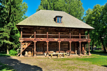 Fototapeta na wymiar Museum of Agriculture in Ciechanowiec, Podlaskie voivodeship, Poland. Wooden cottages, garden, mill, church and other devices used to use by Pollish farmers.