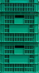 Green plastic crate boxes stacked outdoor under natural light