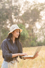 Farmer giving advice on wheat work online on tablet in wheat field