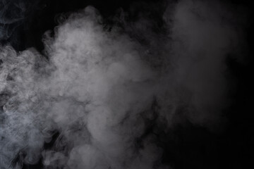 Cloud of white smoke on a black background closeup