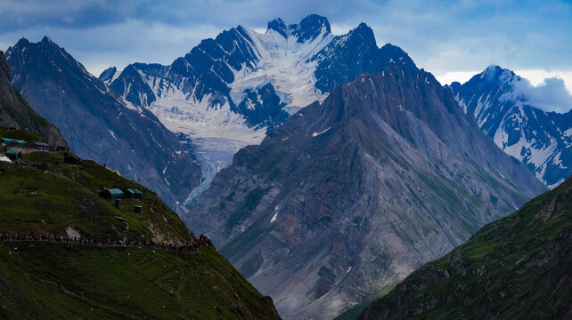 AMARNATH, JAMMU and KASHMIR, INDIA, JULY 06, 2022: Holy Amarnath Cave in Kashmir Himalayas. It is a Hindu shrine dedicated to Shiva. It is one of the holiest shrines in India. Selective focus.
