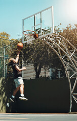 Jumping man, basketball court and scoring goals in fitness workout, training or exercise for health, wellness or professional competition. Sports, energy and player in slam dunk winner game and match © Allistair F/peopleimages.com