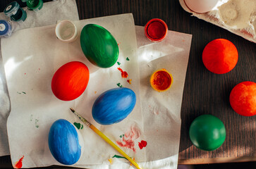 easter theme composition - coloured eggs, paint and brushes 