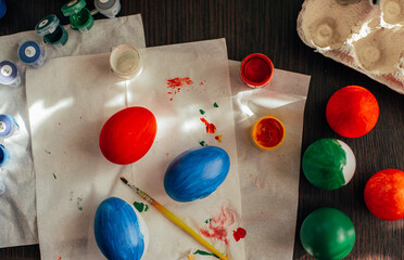 easter theme composition - coloured eggs, paint and brushes 