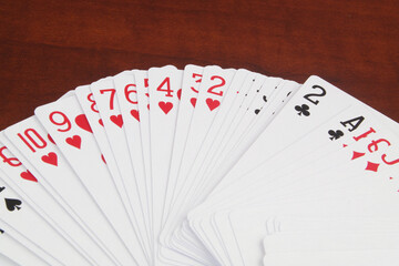 Many playing cards on wooden table close up. Gambling and casino concept.