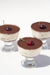 Mousse dessert with cocoa powder and cherry