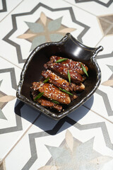 Baked chicken wings with sesame seeds and sauce