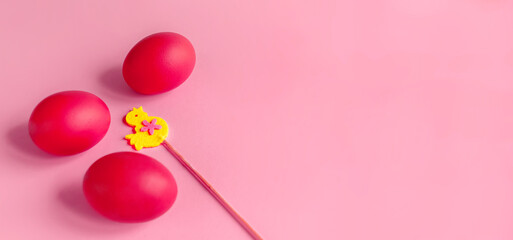Easter card with painted eggs and little chicken made of felt on a stick. Copy space.