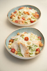 Traditional caesar salad with shrimp and chicken