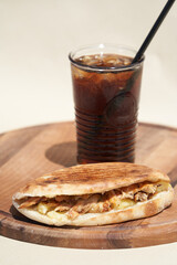 Doner kebab and soda drink on chopping board