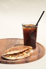 Doner kebab and soda drink on chopping board