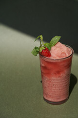 Summer cocktail with strawberry and ice.