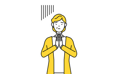 体の前で手を合わせて謝る定年退職したシニア・中年女性