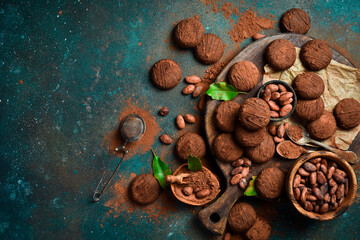 Chocolate cookies with cocoa on a kitchen wooden board. Brownies on a dark background. Top view.