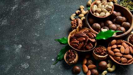Assorted shelled nuts: walnuts, cashews, hazelnuts, Brazil nuts, almonds. Close up, macro. Assortment of shelled nuts. Side view. on the texture table.