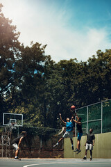 Sports, team and men play basketball in a competition for game or sport players with talent, skill and fitness. People in a competitive training match on outdoor court with teamwork for fun or health