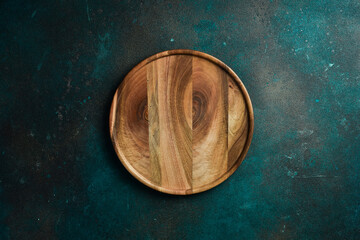 Wooden plate. The dinner plate is made of wood. Top view. on the texture table.
