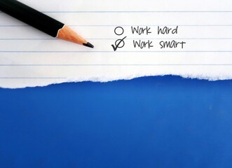 Pencil on torn note paper with checkbox WORK HARD, WORK SMART concept of choosing smart working, finding effective efficient ways to complete  tasks while managing time and quality, not hours