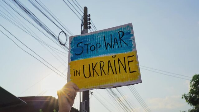 Protester holding a placard about stopping the war in Ukraine
