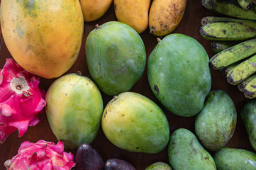 Set of Balinese fruits and vegetables. Banana, dragon fruit, mango, mangosteen, avocado. Flat lay