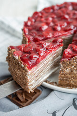 Chocolate crepe cake with cherry on top like black forest cake  close up selective focus