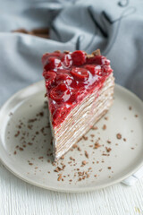 Chocolate crepe cake with cherry on top like black forest cake  close up selective focus