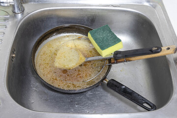 Wash the pan and pour the old oil into the sink. causing clogged sinks and drains.