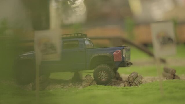 radio-controlled pickup toy car drives along special off-road track. toy for child and specially built track