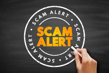 Scam Alert text stamp on blackboard, concept background