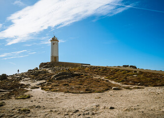Fototapeta na wymiar Roncudo lighthouse and cliffs in Galicia Spain